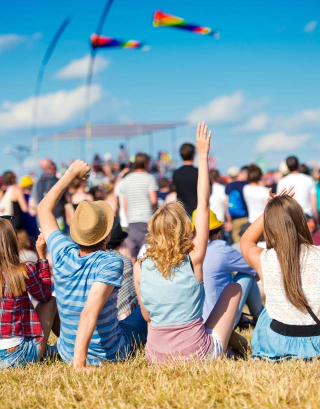 People sitting on the lawn for an outdoor concert