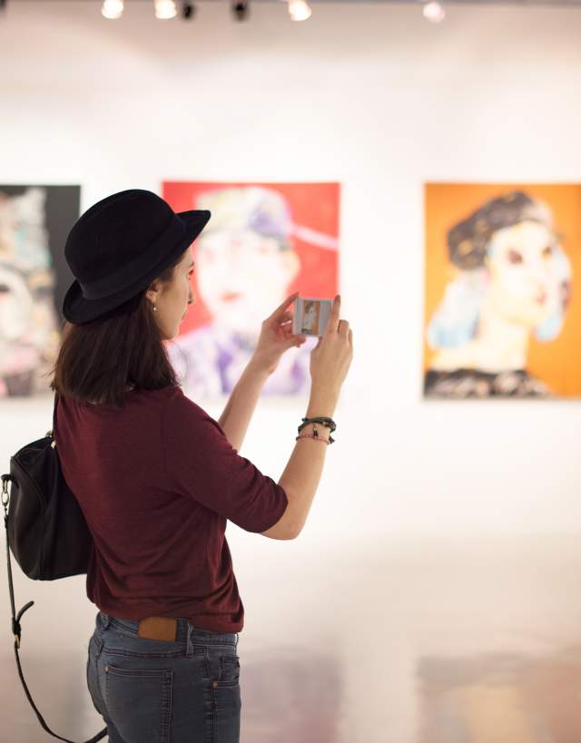 Woman taking pictures at the Irving Arts Center