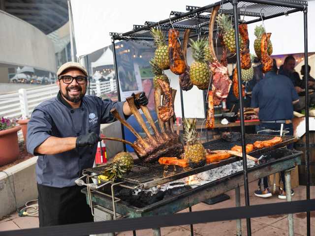 Grillmaster grilling ribs and pineapple for the RARE Steak Championship.