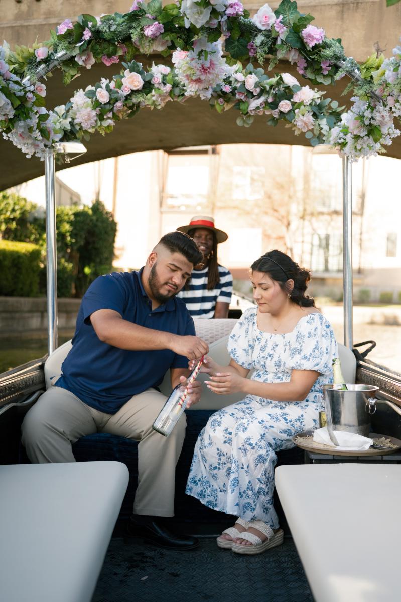 Message in the bottle. Man pulling note out of a bottle that is the proposal.