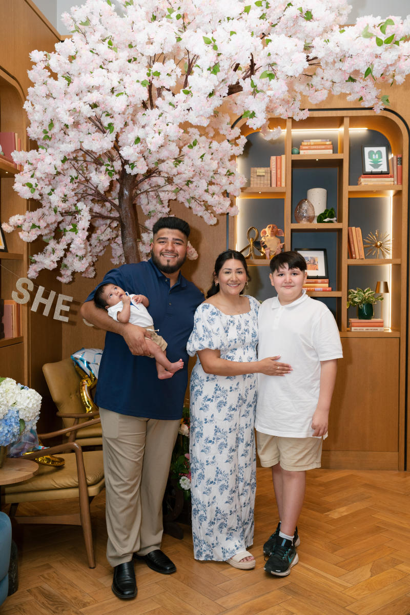Family standing under a cheeryblosm tree at the family celebration