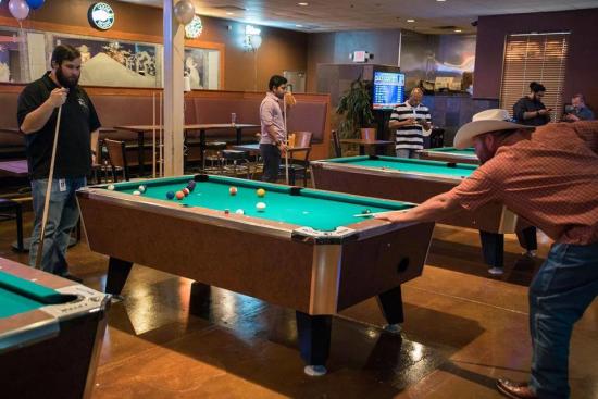 Our Glass two men playing pool