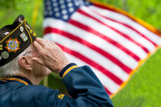 Veteran saluting flag