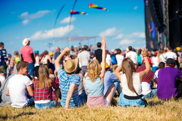 People sitting on the lawn for an outdoor concert