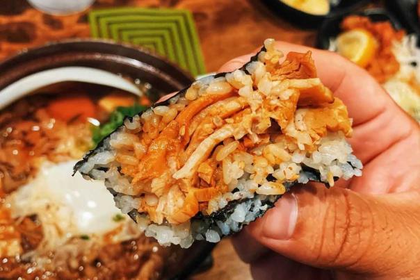 holding handheld sushi