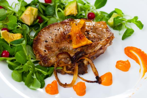 Pork chop with microgreens and pumpkin puree