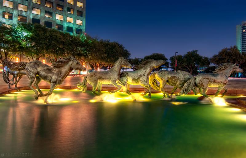 Mustangs of Las Colinas outdoor sculpture at night