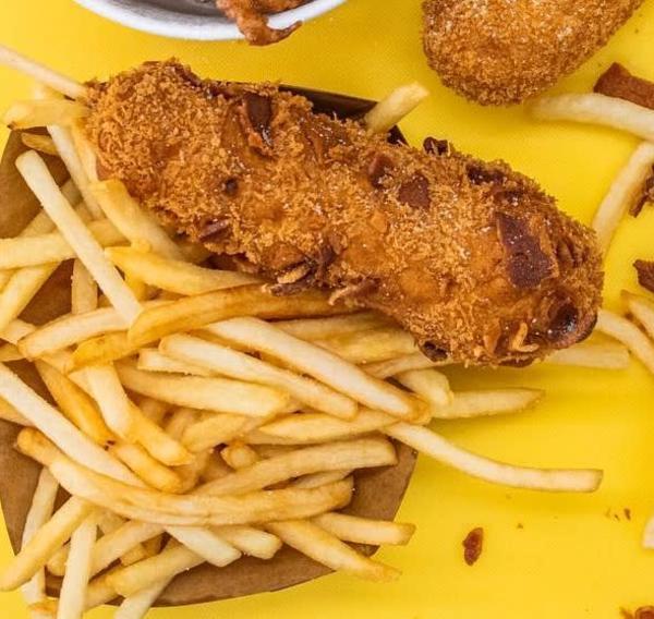 Irving's Unicorn Dog serves up a bacon dog with a side of french fries.
