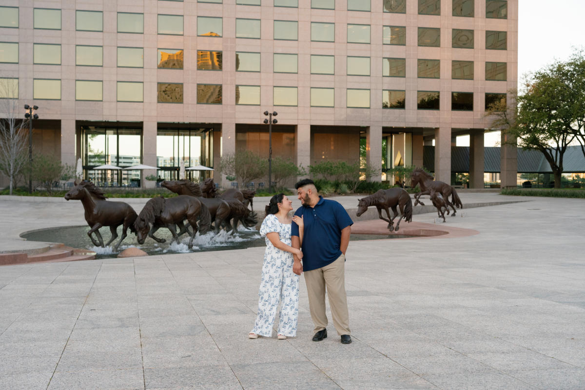 Couple looking at each other at the Mustangs of Las Colinas
