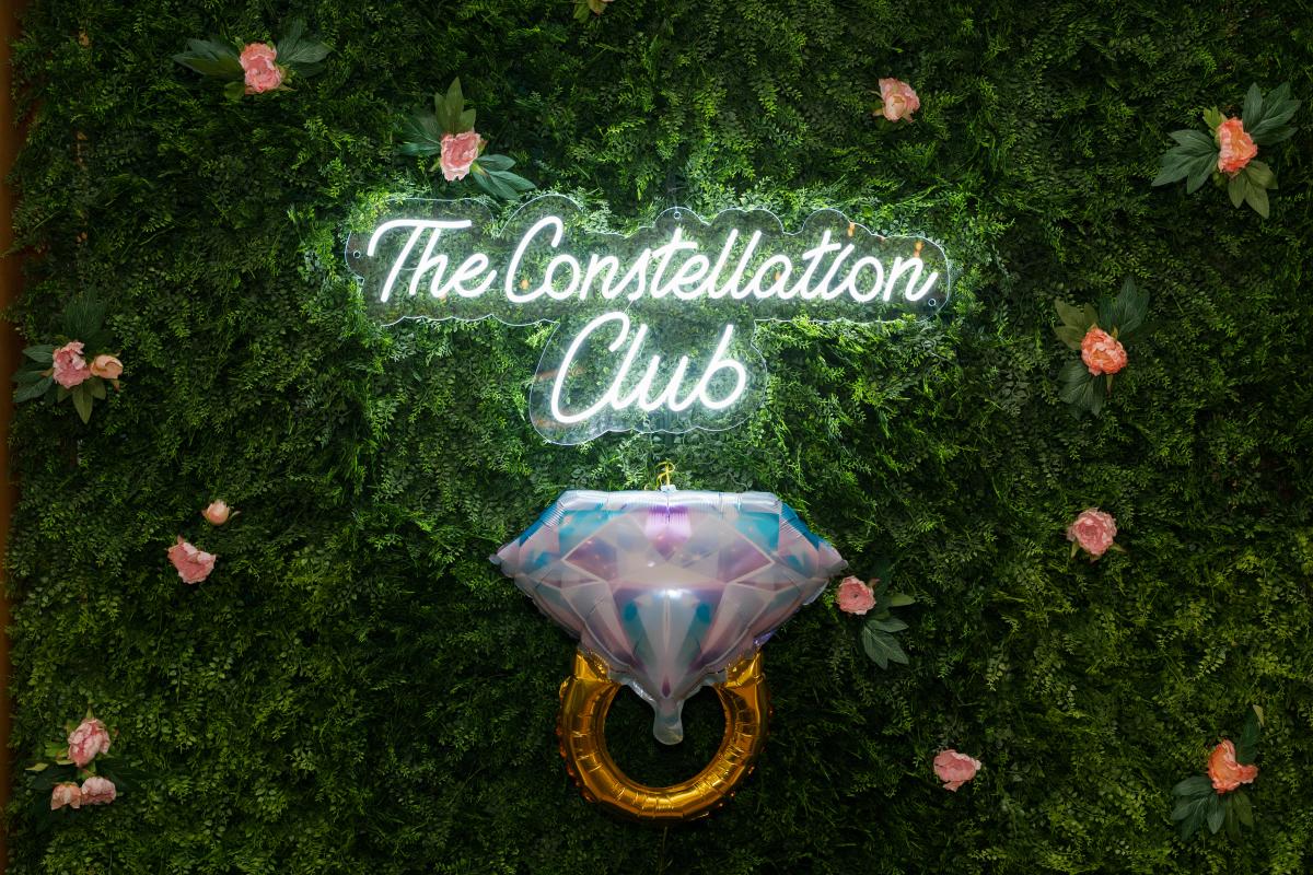Ring on a back drop with signage for the Constellation Club