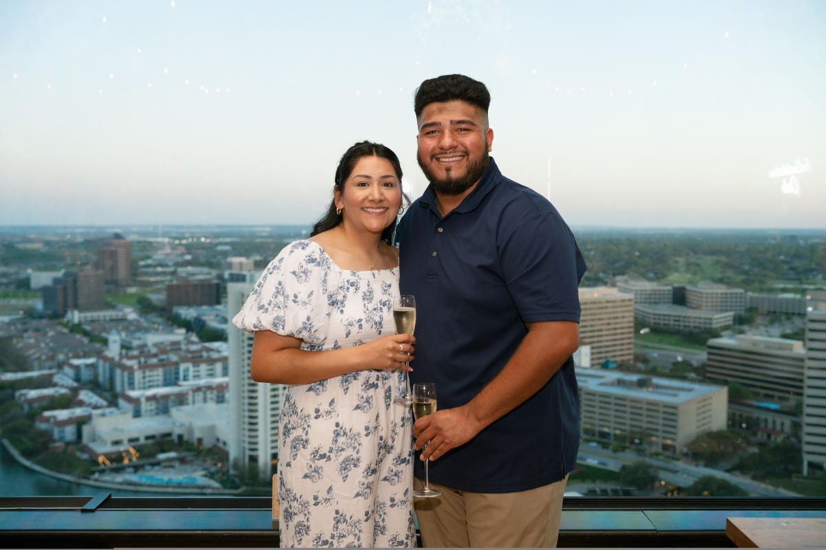 Celebrating with the couple with Irving as their backdrop