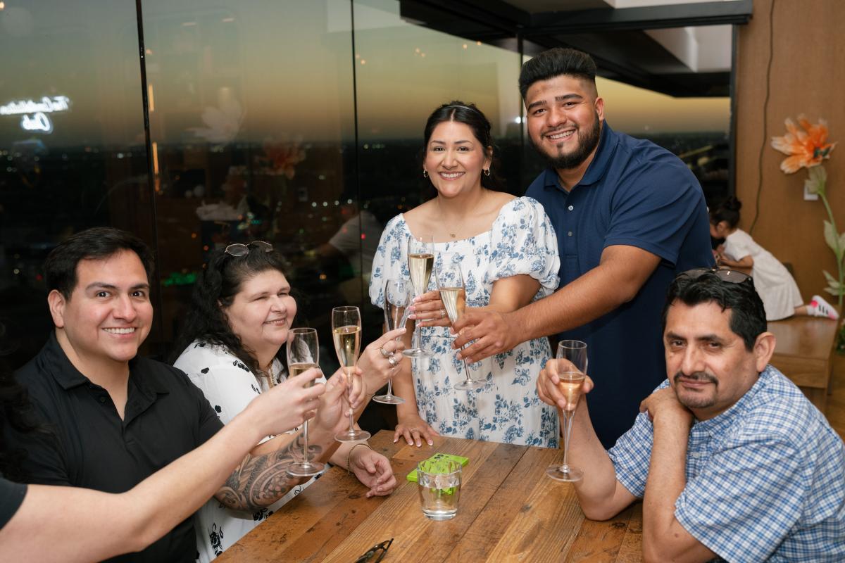 The Couple celebrates at The Constellation Club while the sun sets behind them