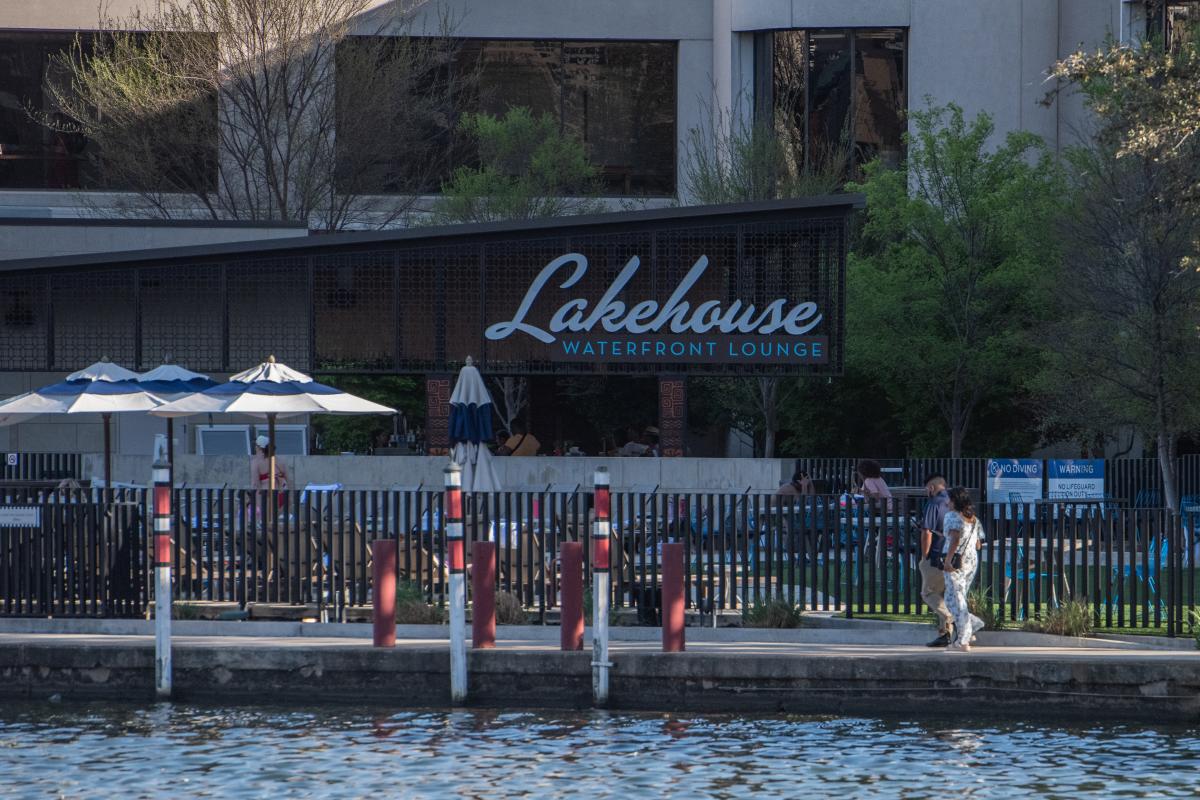 Couple walking along The Lakehouse at The Omni Las Colinas
