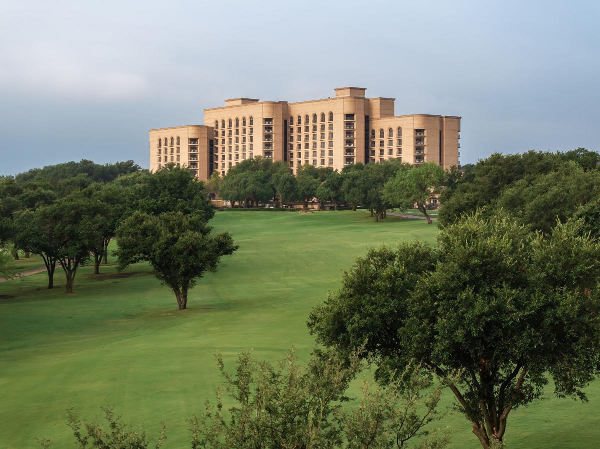 Exterior photo of Ritz Carlton Las Colinas with manicured trees and green lawn