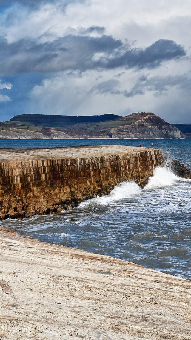Lyme Regis Cobb and dramatic clouds