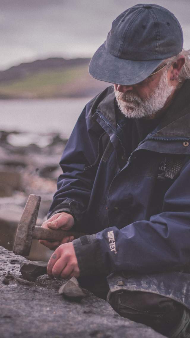 A man fossil hunting in Lyme Regis