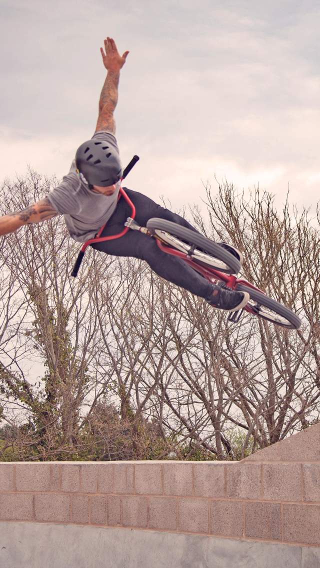 BMX rider jumping off a wall