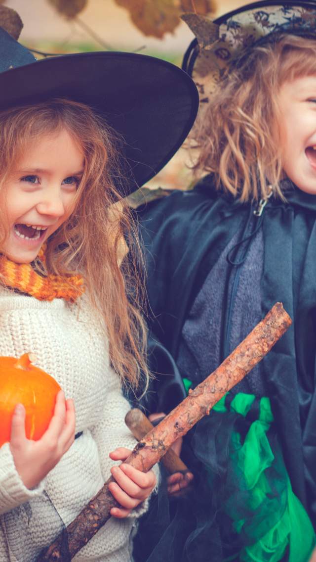 Two girls wearing Halloween costumes on a wildlife trail at Studland Bay in Dorset