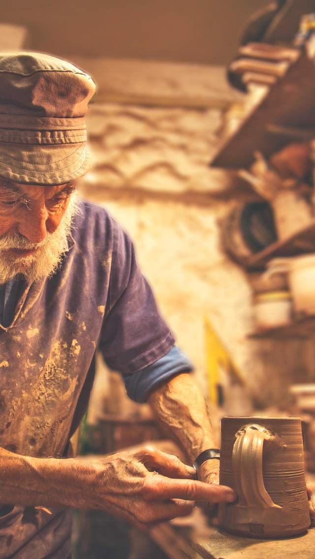 Potter making a cup out of clay