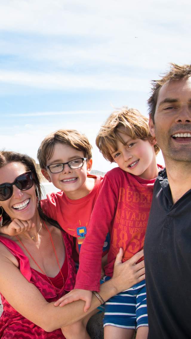 Family taking a photo selfie at West Bay in Dorset
