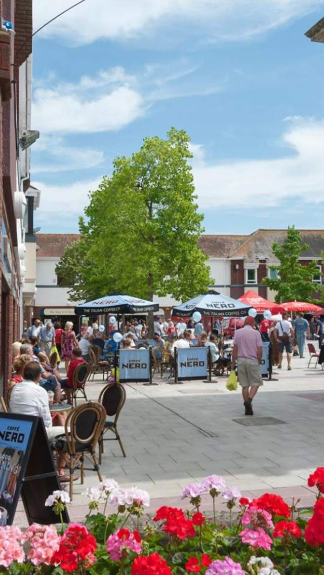 People sitting out at the cafes in Saxon Square, Christchurch, Dorset