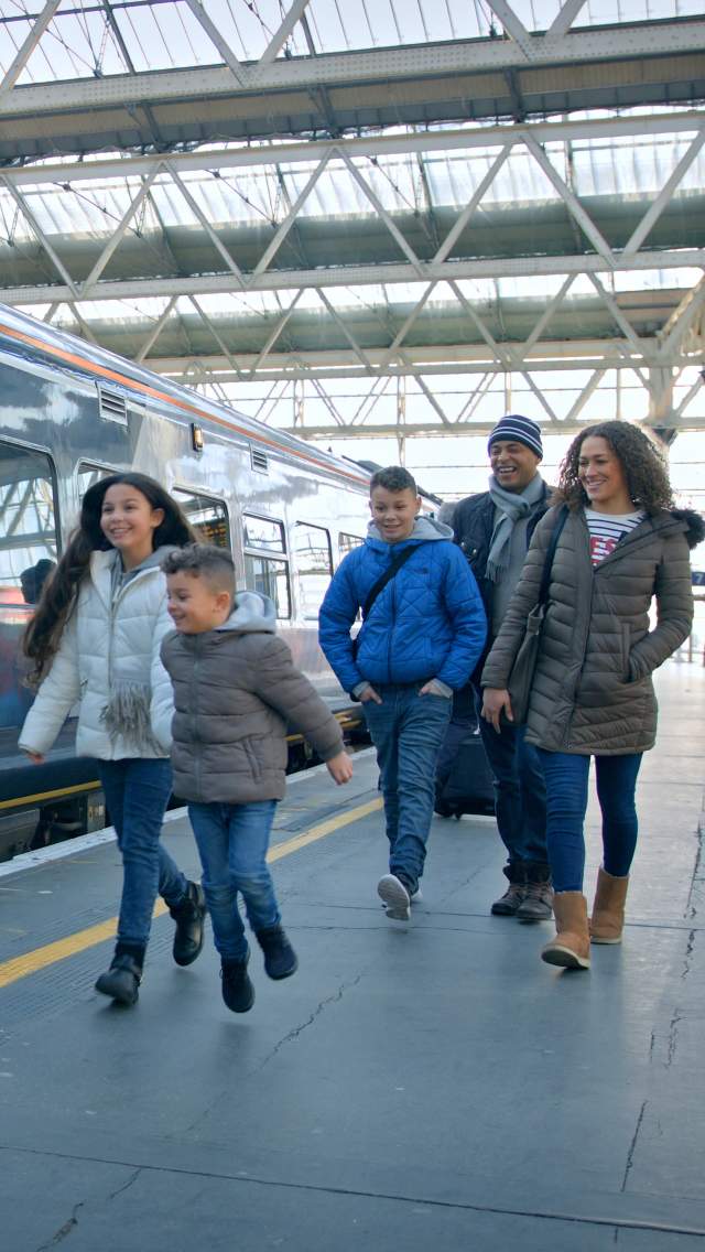 Family boarding South Western Railway train