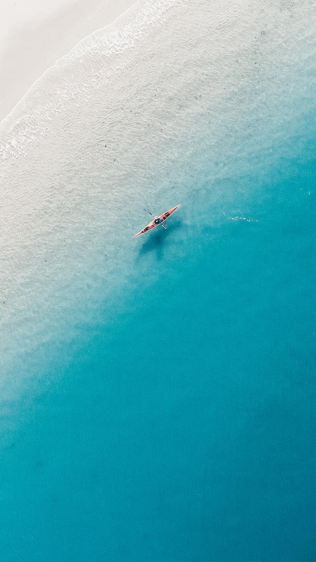 Kayaker in turquoise sea at Old Harry Rocks, Dorset