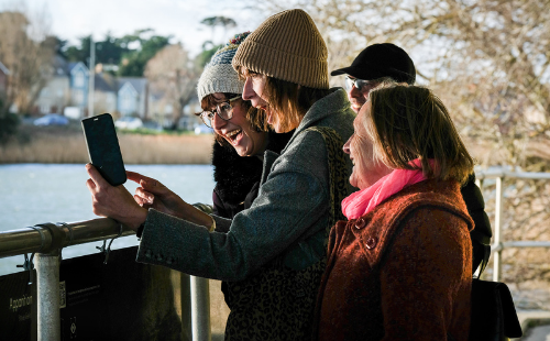 A group enjoying the Sculpture Apparition by Steve Geliot