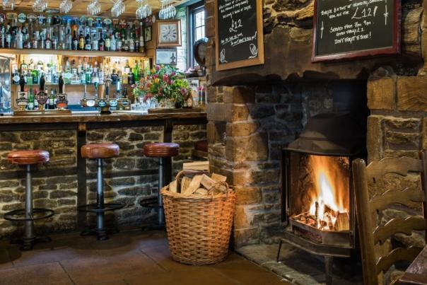 Bar with log fire at The Acorn Inn pub, Dorset