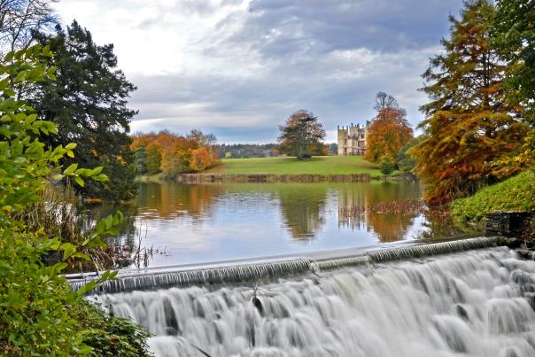 Sherborne Castle lake and water cascade in autumn