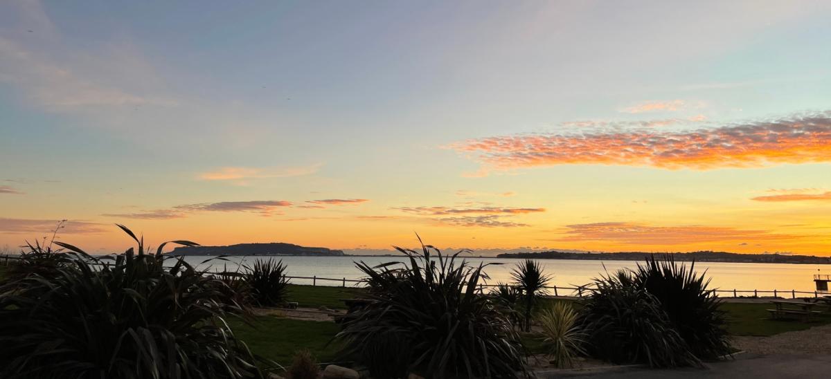 A sunset over Weymouth Bay viewed from Bowleaze Cove Holiday Park & Spa in Dorset