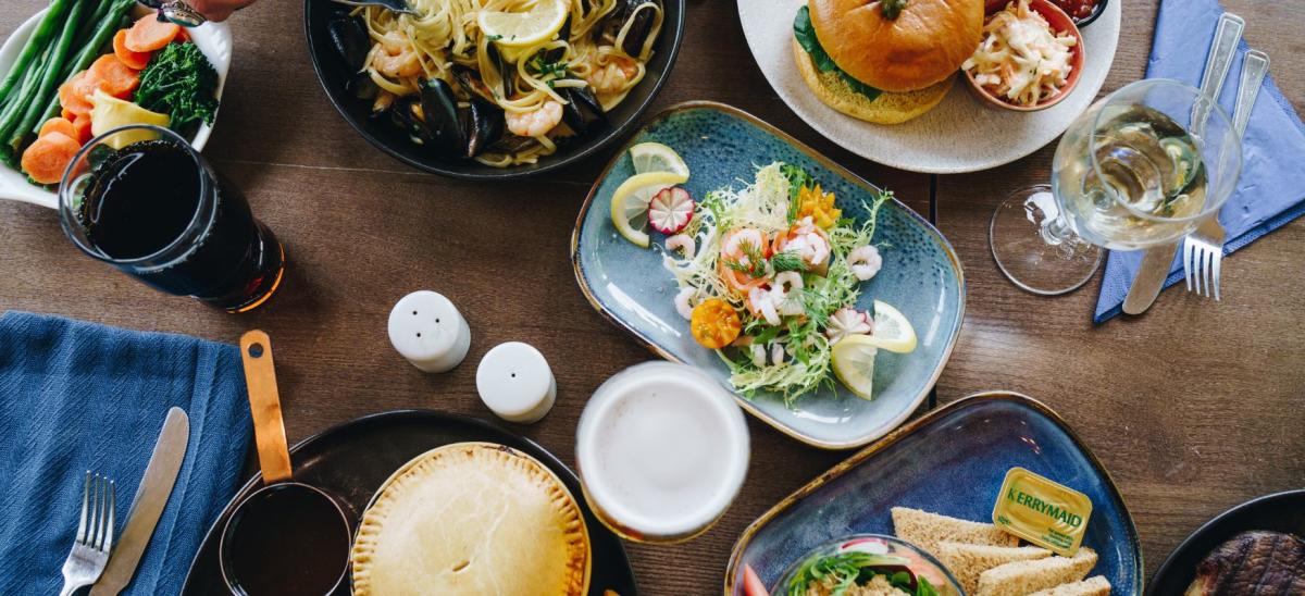 Plates of food with drinks, cutlery and napkins on the table at The Country Club in Dorset