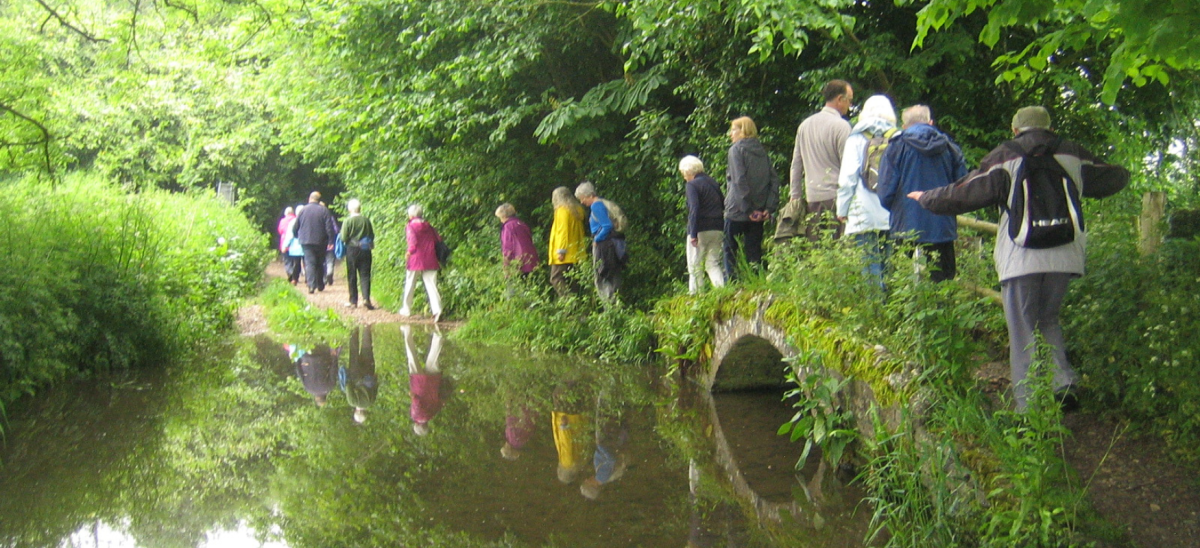Walkers cross a little bridge in Dorchester