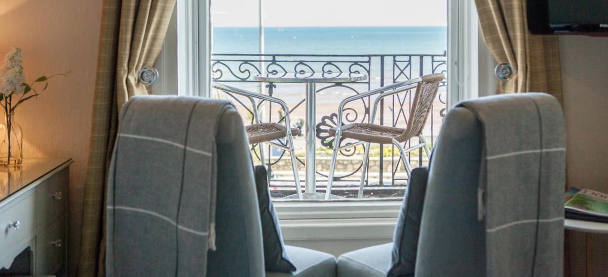 Gloucester House bedroom with balcony overlooking Weymouth Beach in Dorset