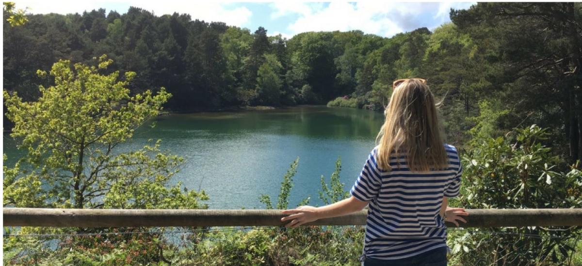 Woman looking at Blue Pool, Wareham, Dorset
