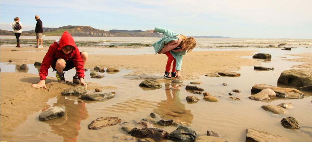 Two children fossil hunting at Lyme Regis in Dorset