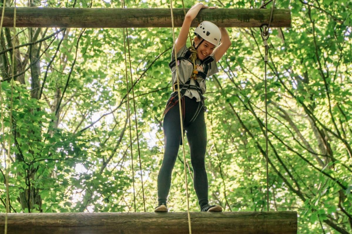 Girl taking part in a high ropes course with Cumulus Outdoors